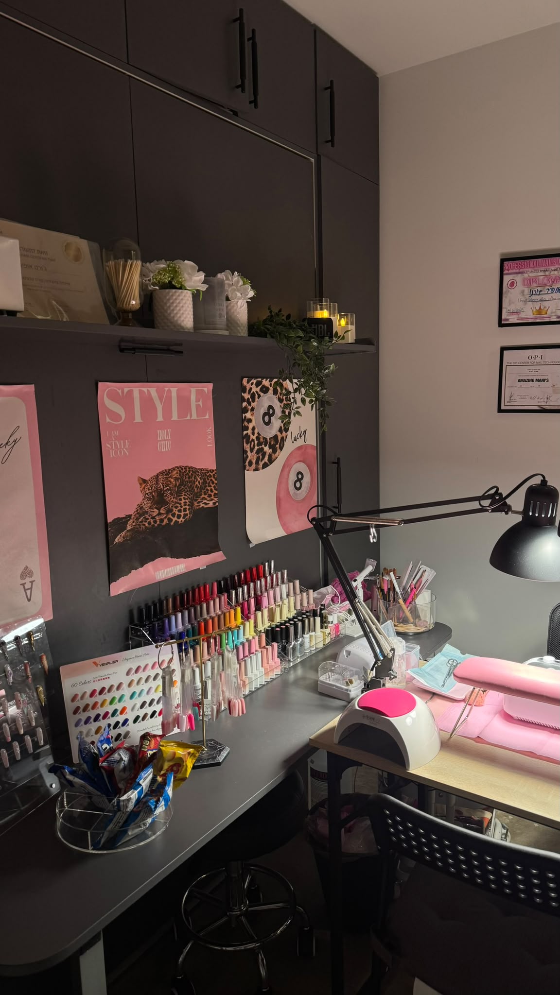 Ofirush studio interior with manicure table, polish display, lamp and framed art