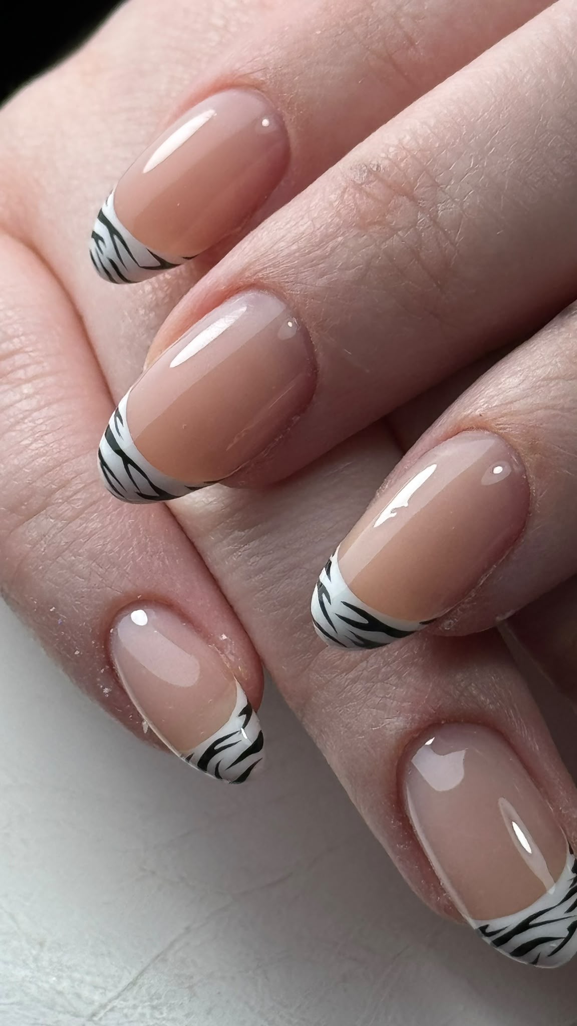 French nail design with zebra-pattern accents
